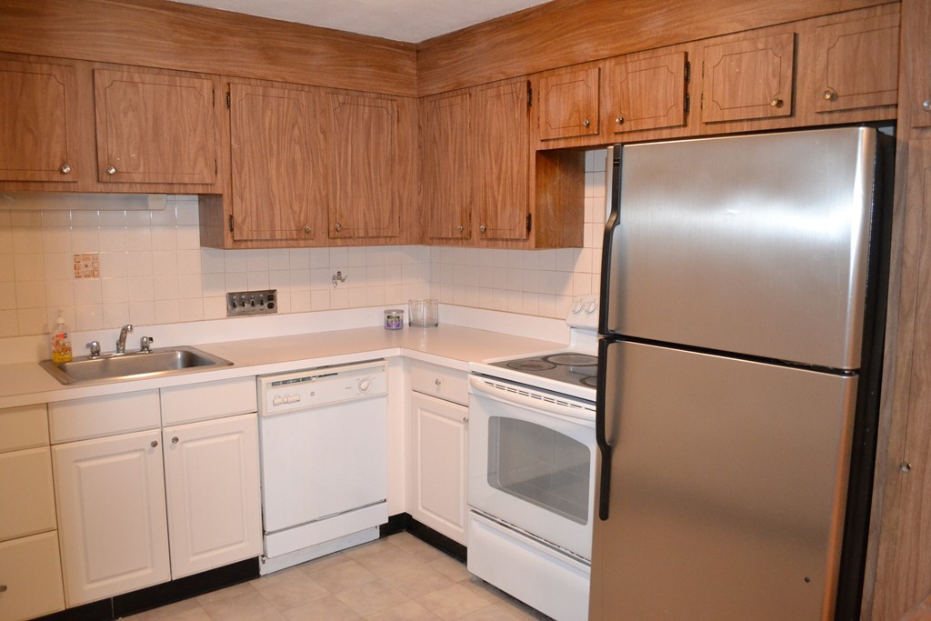 100 Summer Street, Unit 14 Watertown, MA 02472 - Photo 6 of 9 a utility room with cabinets washer and dryer