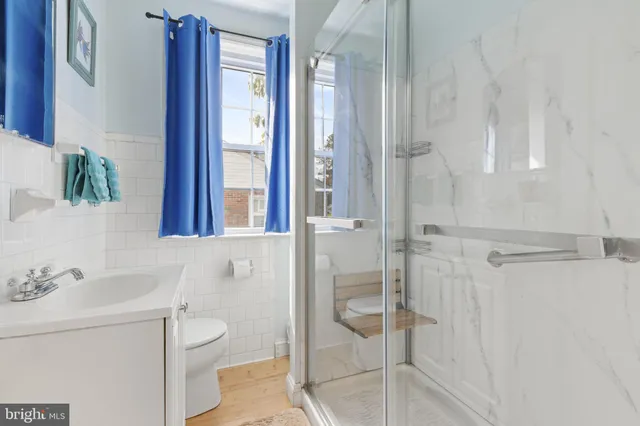 a bathroom with a shower toilet and sink
