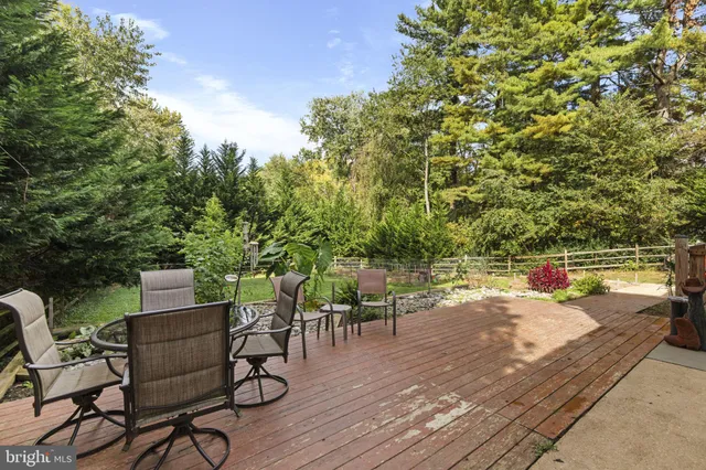 an outdoor space with patio and wooden floor