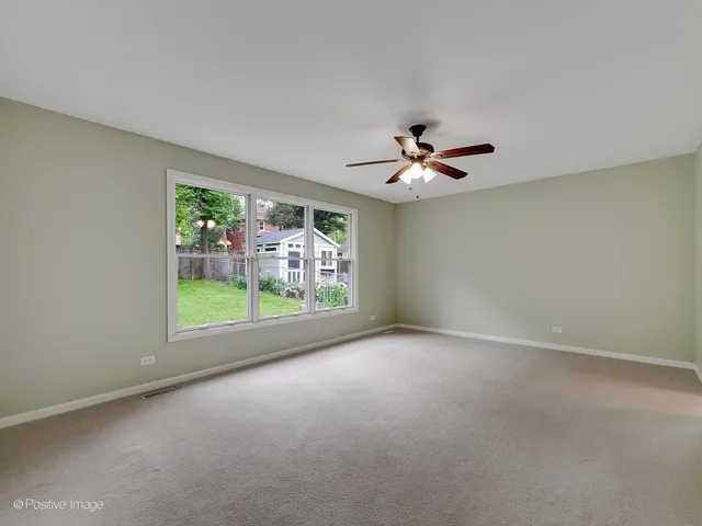 a view of a livingroom with a ceiling fan and couch