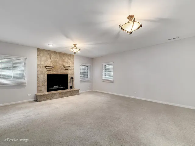 a view of empty room with a fireplace