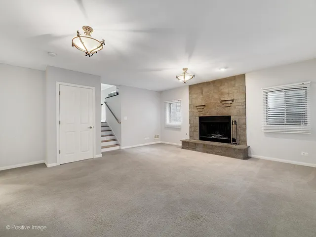 a view of empty room with fireplace and stairs