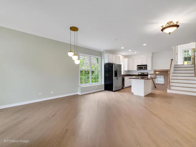 a view of a kitchen with a sink wooden floor and a kitchen