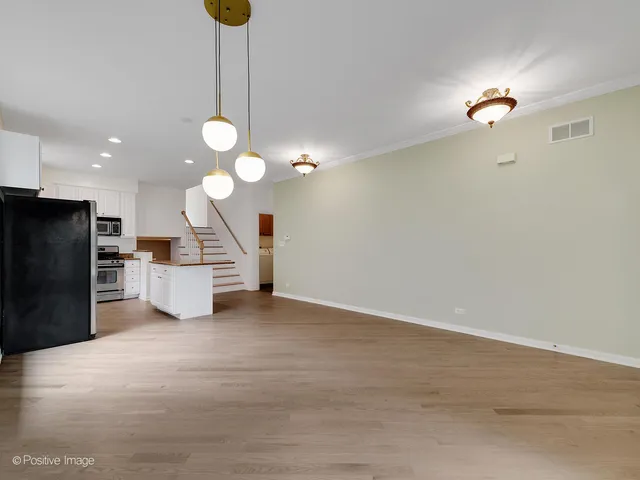 a view of a kitchen with a sink and a chandelier