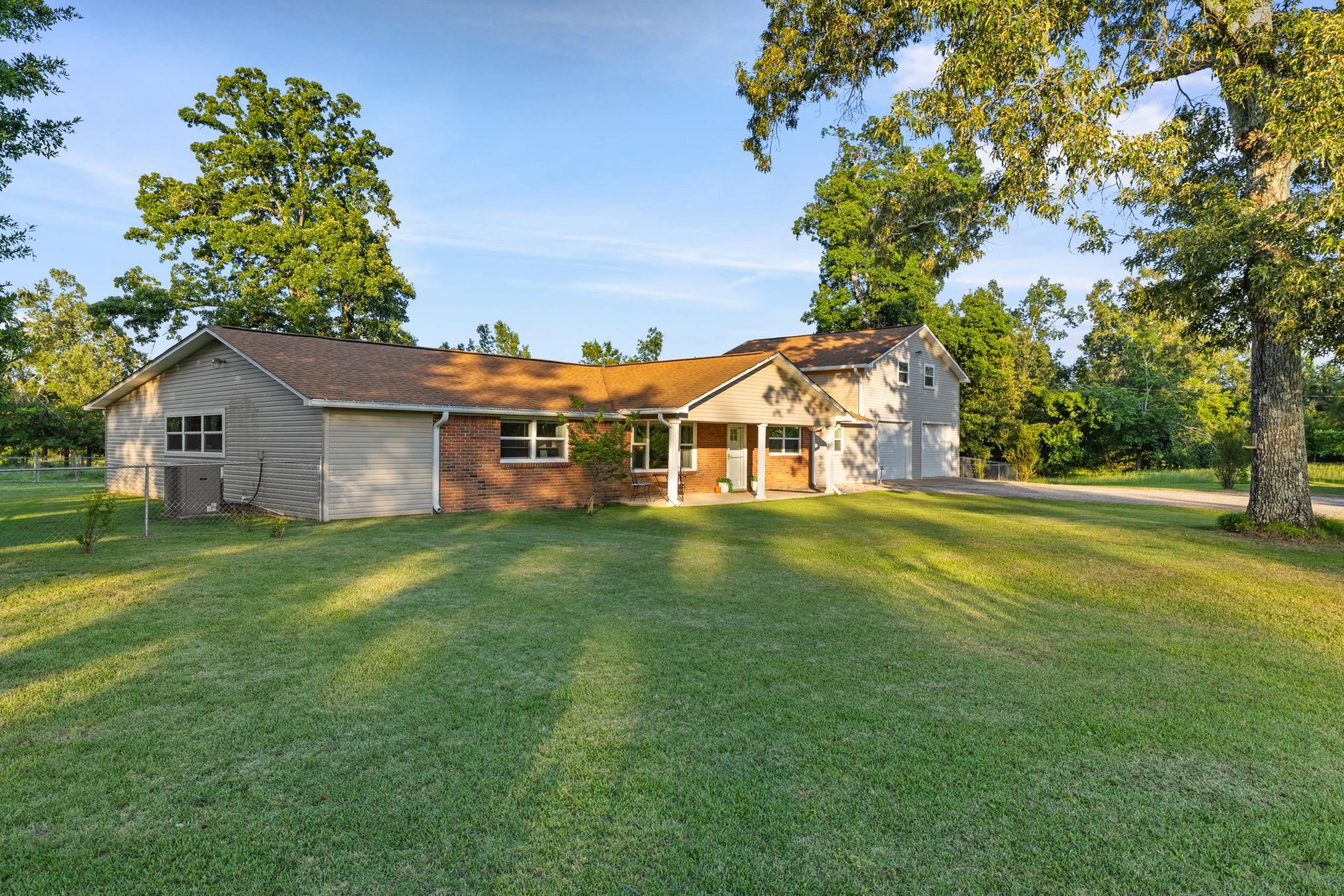 66 County Road 511 Corinth, MS 38834 - Photo 2 of 40 Expansive front yard with a brick and siding exterior, a covered entryway, and two attached garages