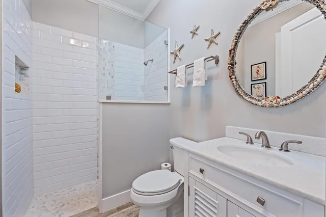 a spacious bedroom with a bed a dresser and a window