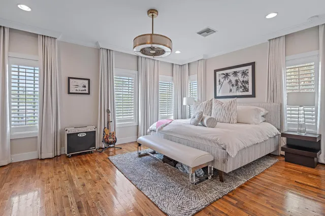 a view of a livingroom with furniture wooden floor cabinet and window