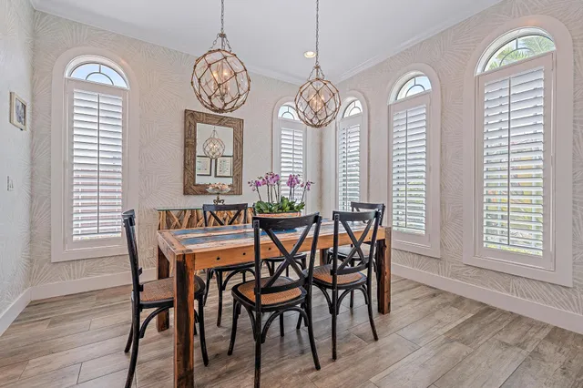 a kitchen with a table chairs sink and cabinets