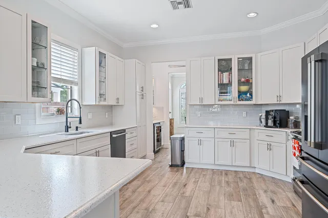 a kitchen with stainless steel appliances a stove refrigerator sink and cabinets