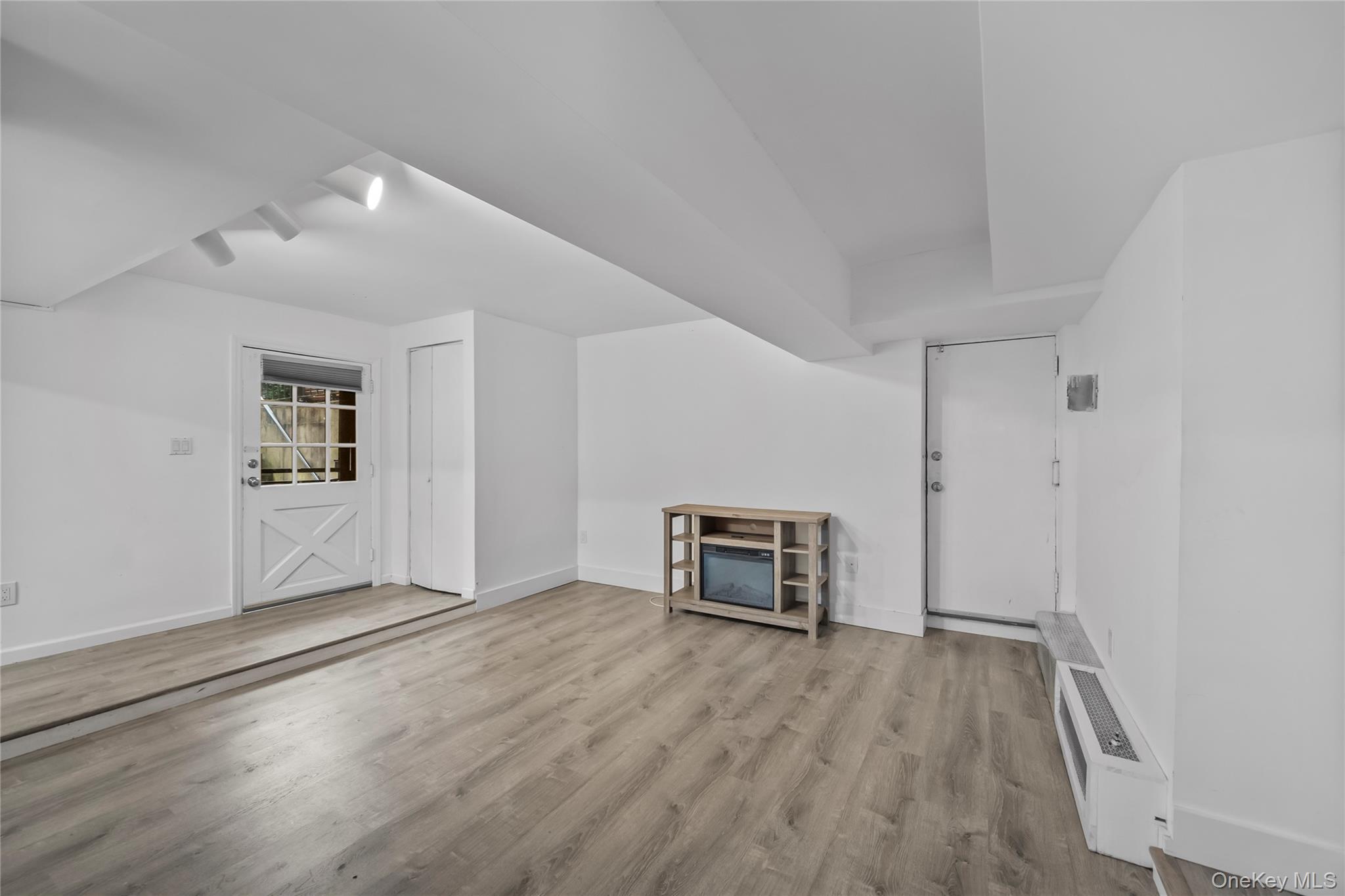 1440 Boston Post Road, Unit 8K Larchmont, NY 10538 - Photo 11 of 20 Unfurnished living room featuring wood finished floors and baseboards