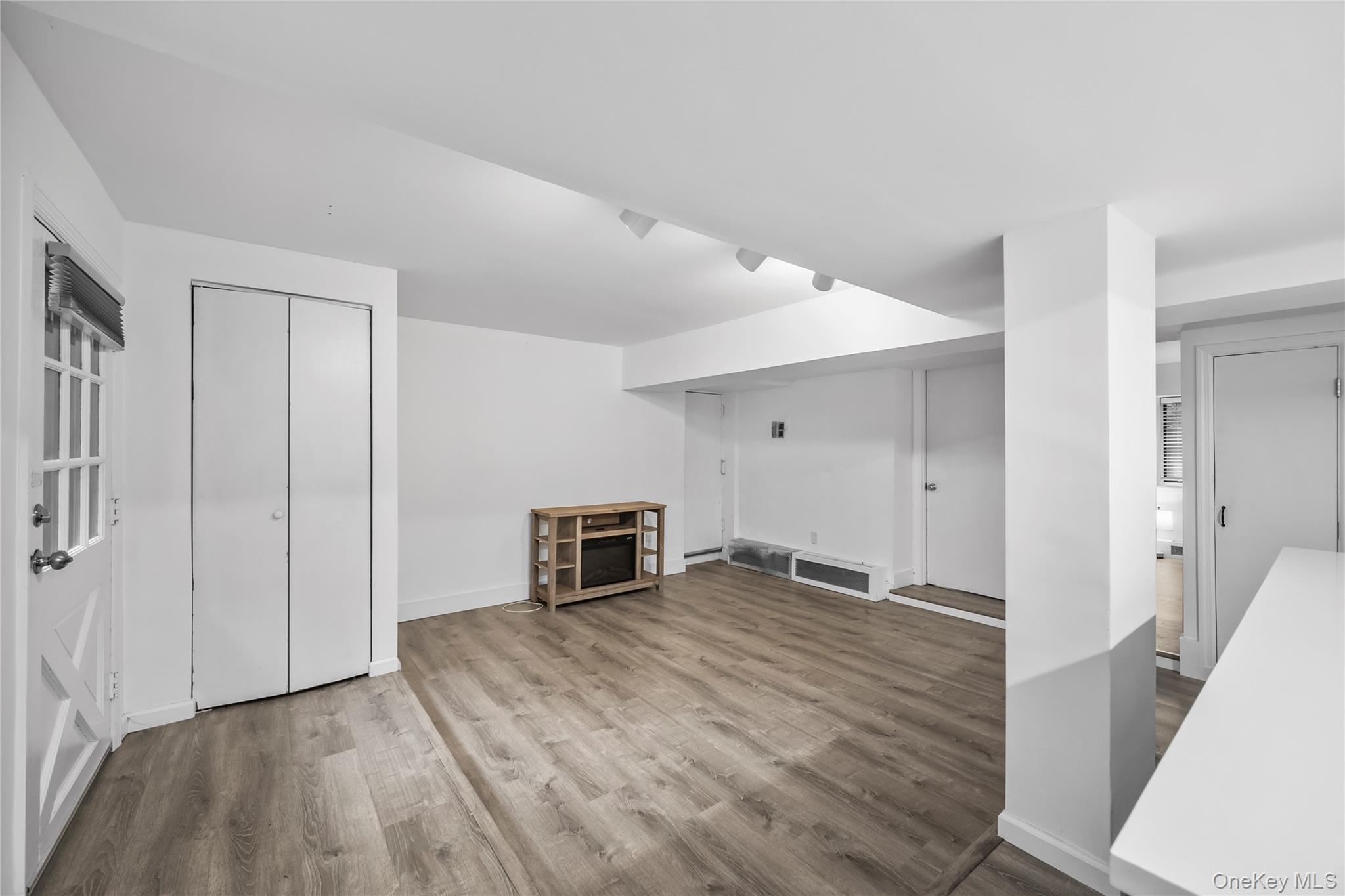 1440 Boston Post Road, Unit 8K Larchmont, NY 10538 - Photo 4 of 20 Unfurnished living room with wood finished floors and baseboards