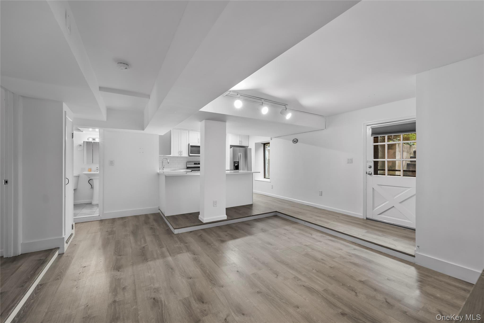 1440 Boston Post Road, Unit 8K Larchmont, NY 10538 - Photo 9 of 20 Unfurnished living room with track lighting and wood finished floors