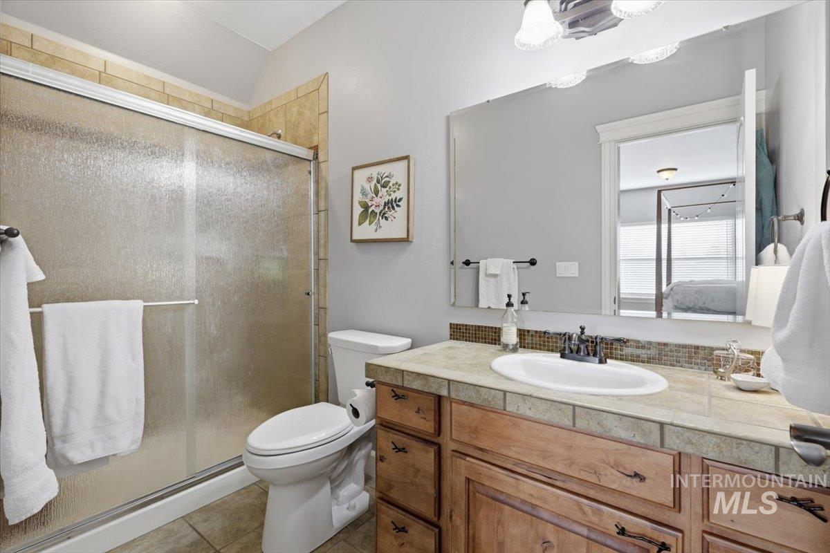 8982 New Castle Drive Middleton, ID 83644 - Photo 25 of 48 Full bath with vanity, a stall shower, and light tile patterned flooring