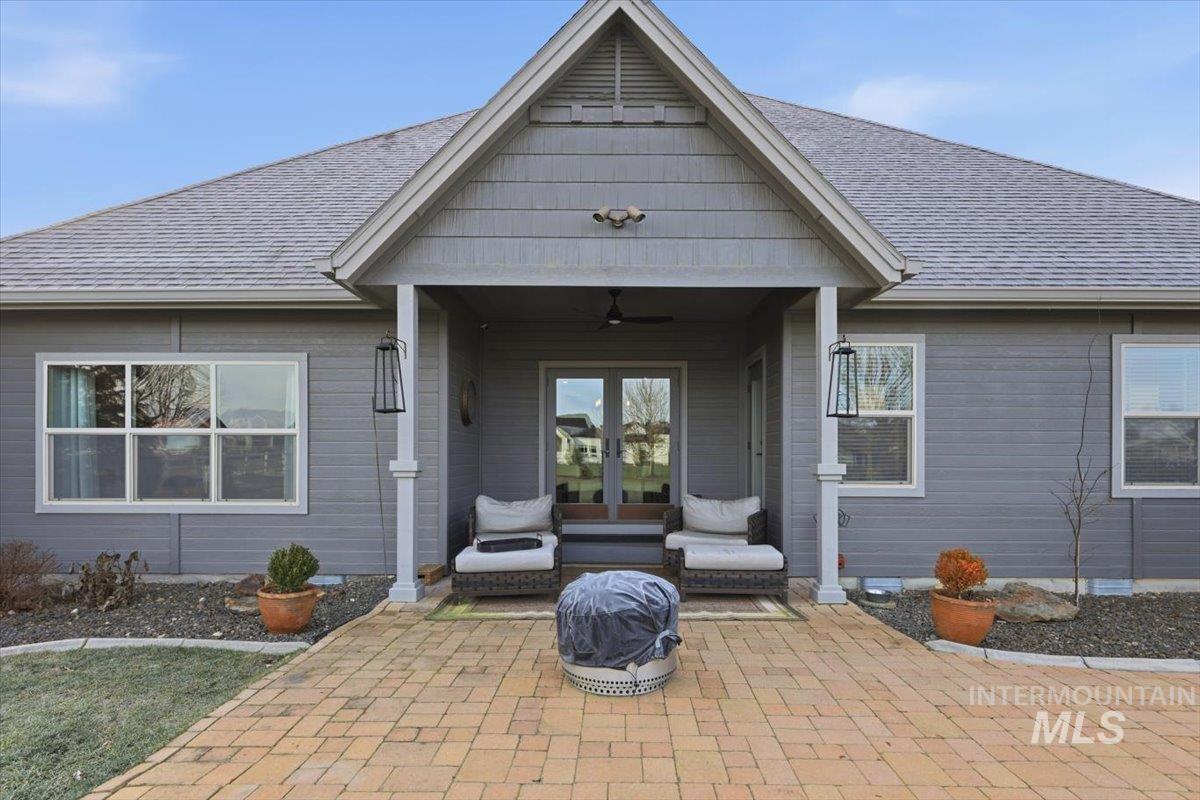 8982 New Castle Drive Middleton, ID 83644 - Photo 31 of 48 Doorway to property featuring french doors, a patio area, a ceiling fan, and a shingled roof