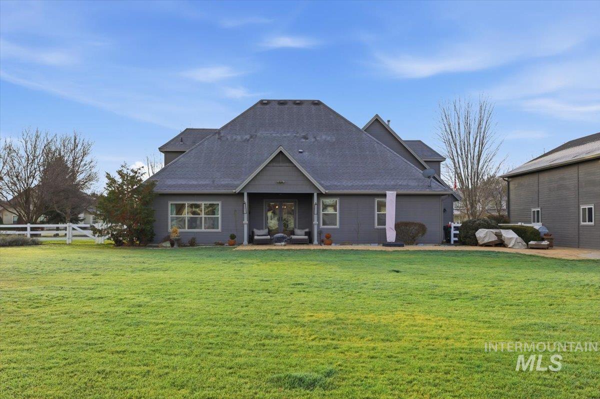 8982 New Castle Drive Middleton, ID 83644 - Photo 34 of 48 Back of house featuring a lawn and a shingled roof