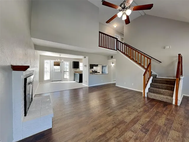 a view of staircase and kitchen with wooden floor