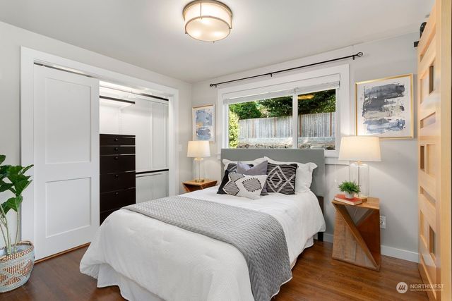 a bedroom with a large bed and a potted plant