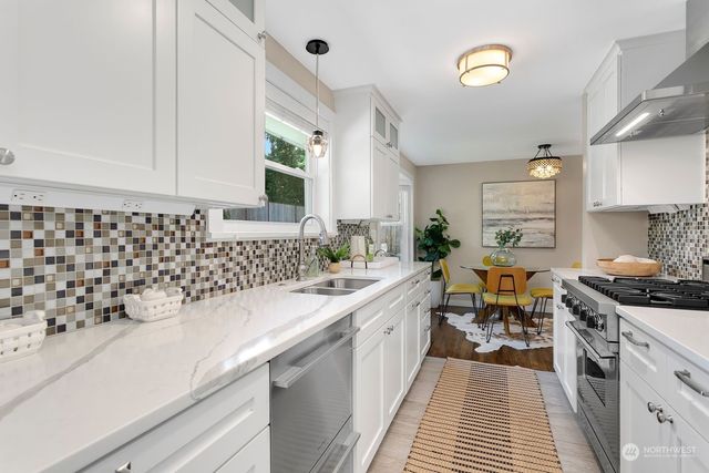 a kitchen with a sink stove and cabinets