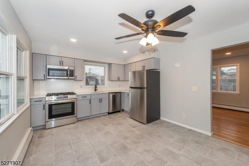 a kitchen with stainless steel appliances a refrigerator sink and stove