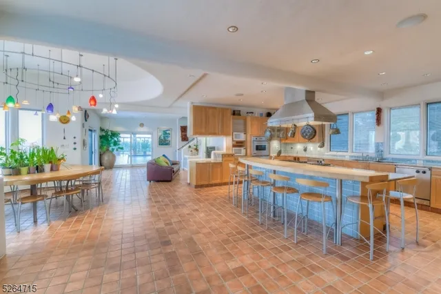a kitchen with lots of wooden furniture a dining table and chairs