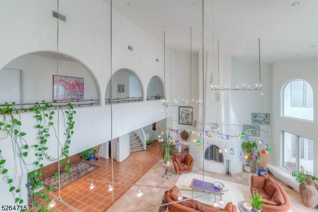 a spacious bedroom with a bed and a chandelier