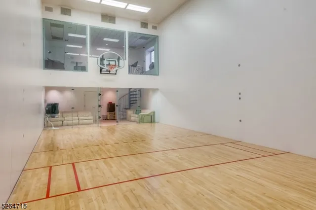 a room with stainless steel appliances wooden floor and view living room