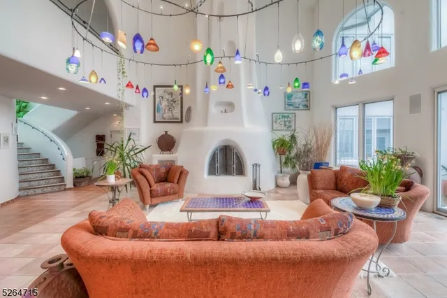 a living room with furniture and a chandelier