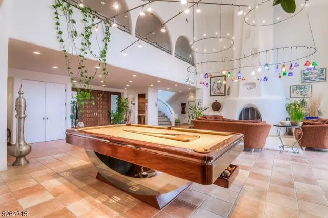 a room with table tennis air hockey table and arcade game machine