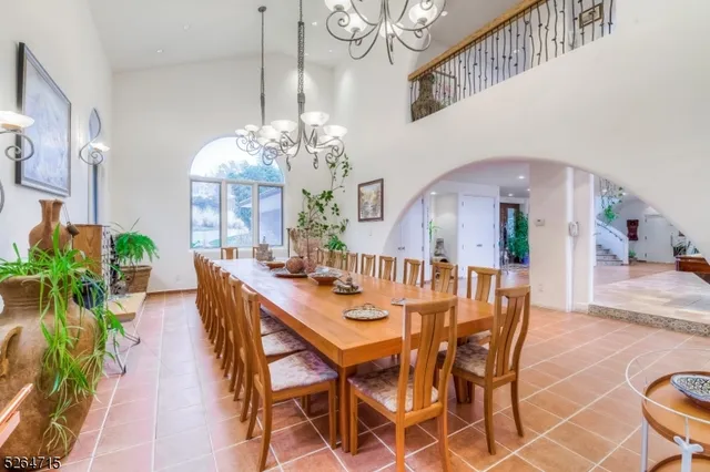 a view of a dining room with furniture and a chandelier