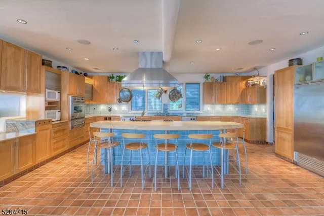 a kitchen with granite countertop a sink cabinets and stainless steel appliances
