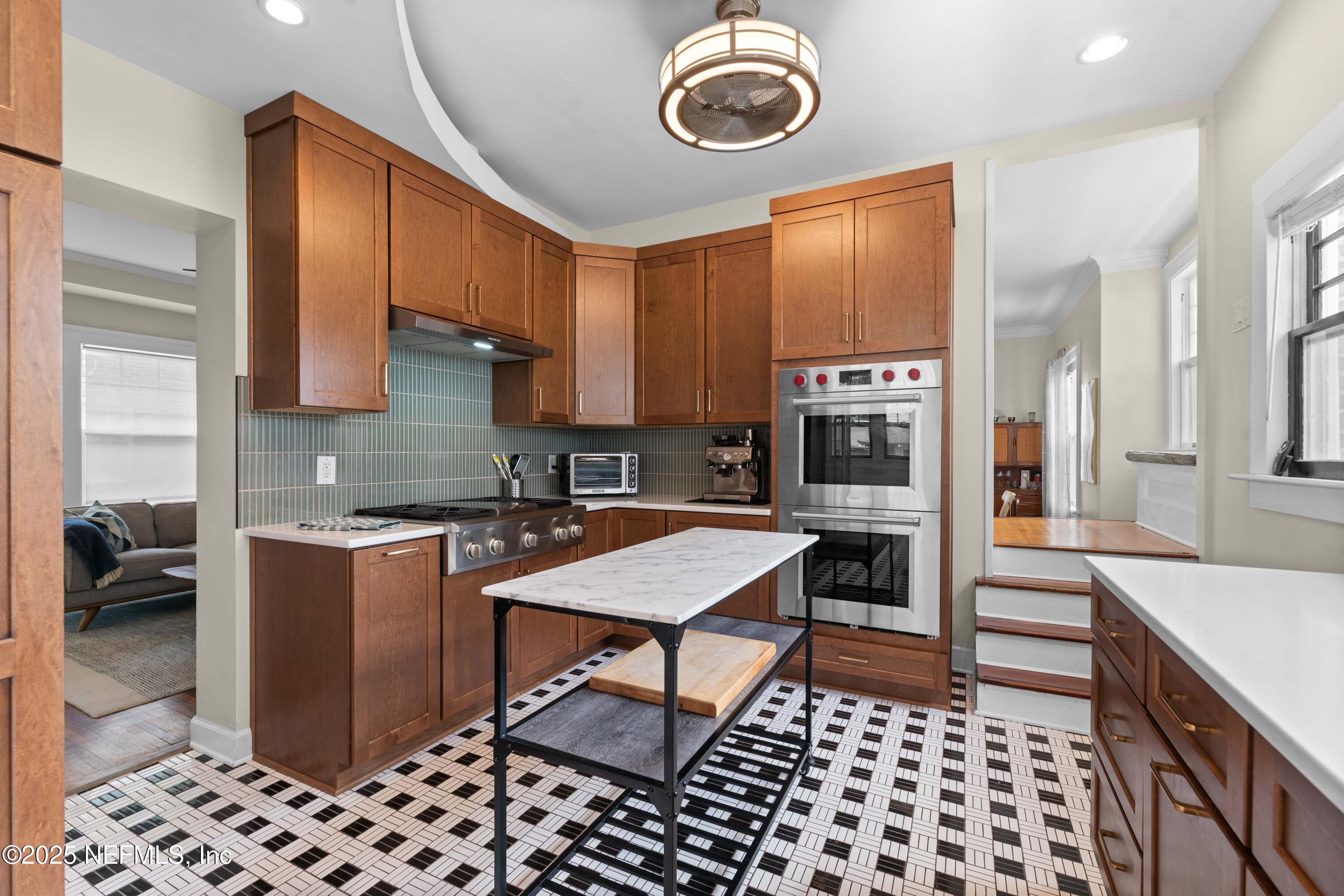3023 Oak Street Jacksonville, FL 32205 - Photo 20 of 50 a kitchen with stainless steel appliances a stove a sink a microwave a refrigerator and cabinets