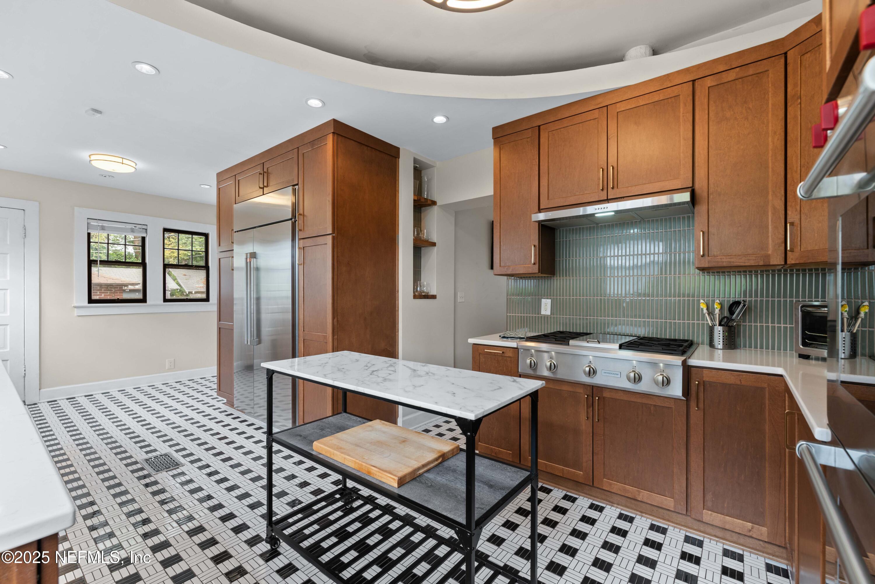 3023 Oak Street Jacksonville, FL 32205 - Photo 21 of 50 a kitchen with stainless steel appliances granite countertop a stove a sink dishwasher and cabinets