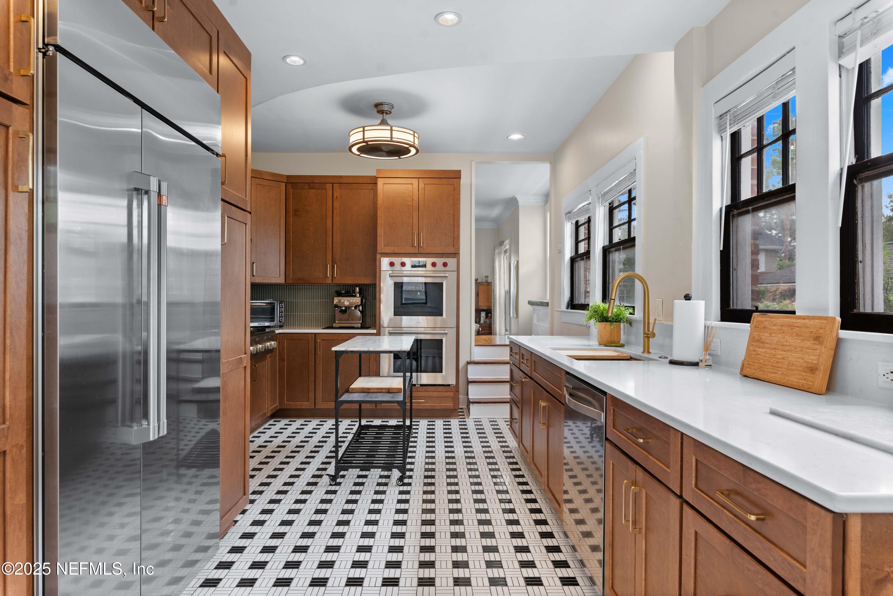3023 Oak Street Jacksonville, FL 32205 - Photo 22 of 50 a kitchen with stainless steel appliances kitchen island granite countertop a refrigerator and a sink