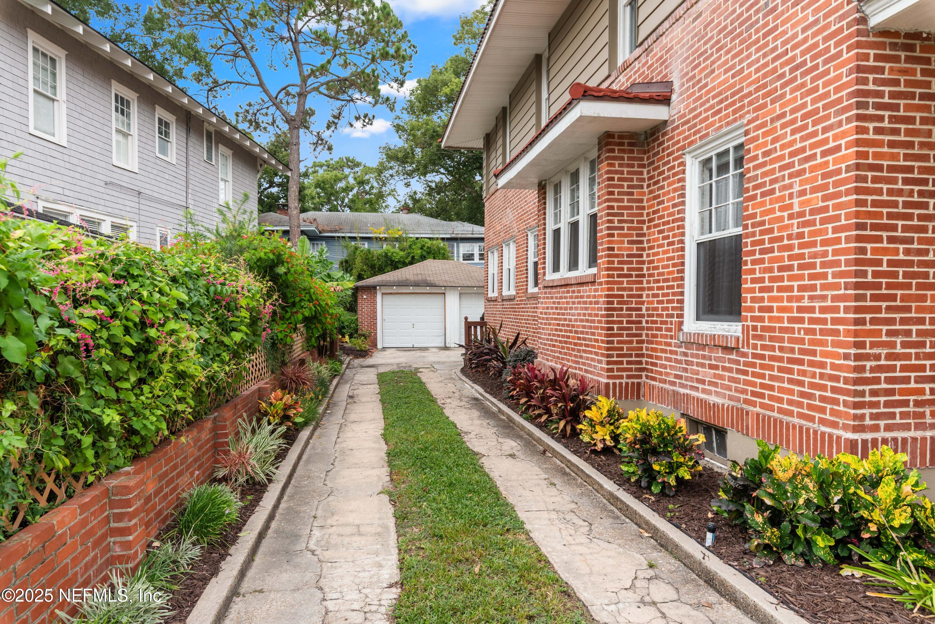 3023 Oak Street Jacksonville, FL 32205 - Photo 39 of 50 a front view of a house with a yard and flowers