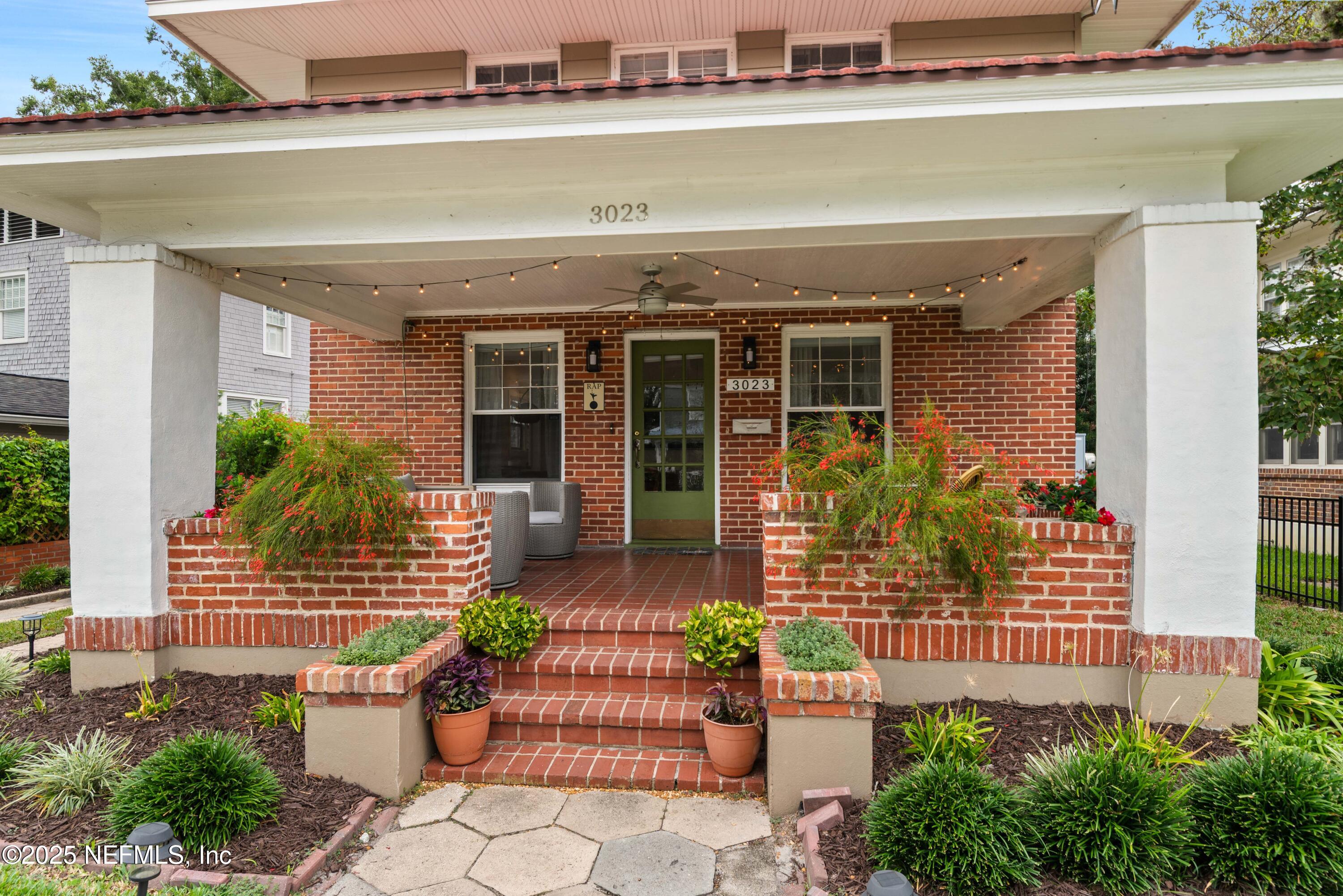 3023 Oak Street Jacksonville, FL 32205 - Photo 4 of 50 a front view of a house with outdoor seating and plants