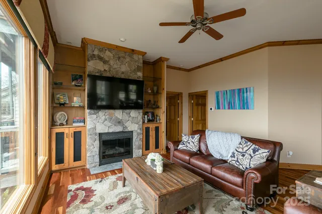 a living room with furniture a flat screen tv and a fireplace