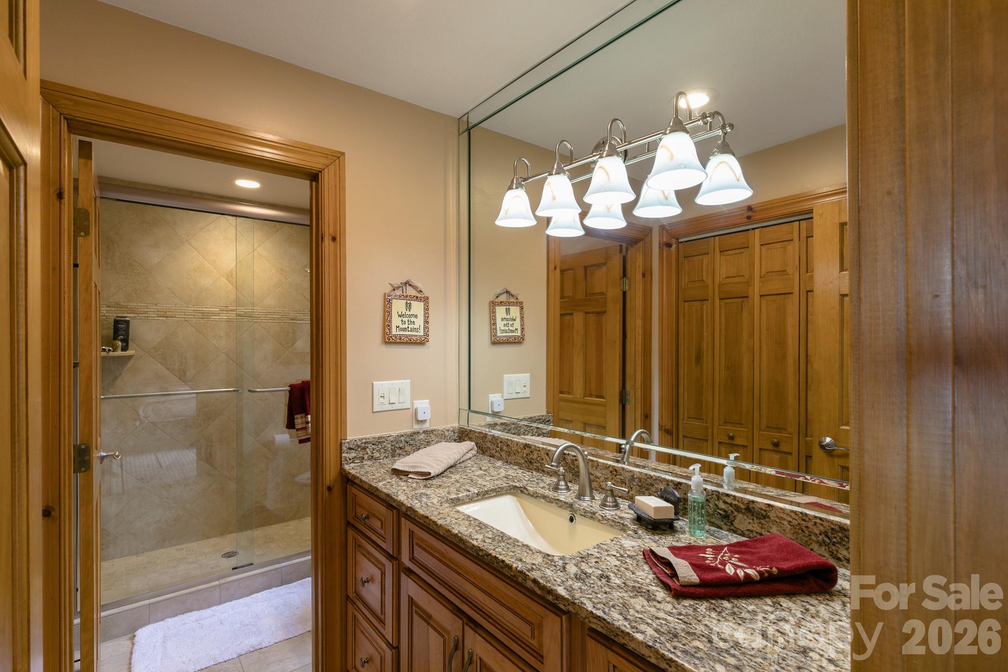 140 Slickrock Road, Unit F3 Burnsville, NC 28714 - Photo 18 of 31 a bathroom with a granite countertop sink and a mirror