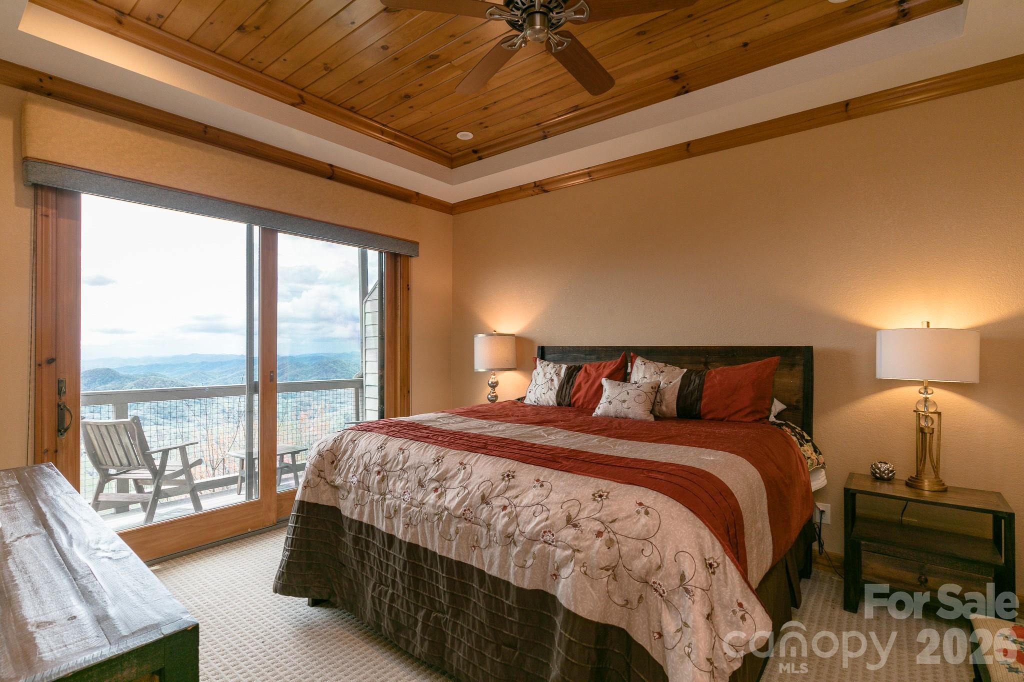 140 Slickrock Road, Unit F3 Burnsville, NC 28714 - Photo 19 of 31 a bedroom with a large bed and a large window