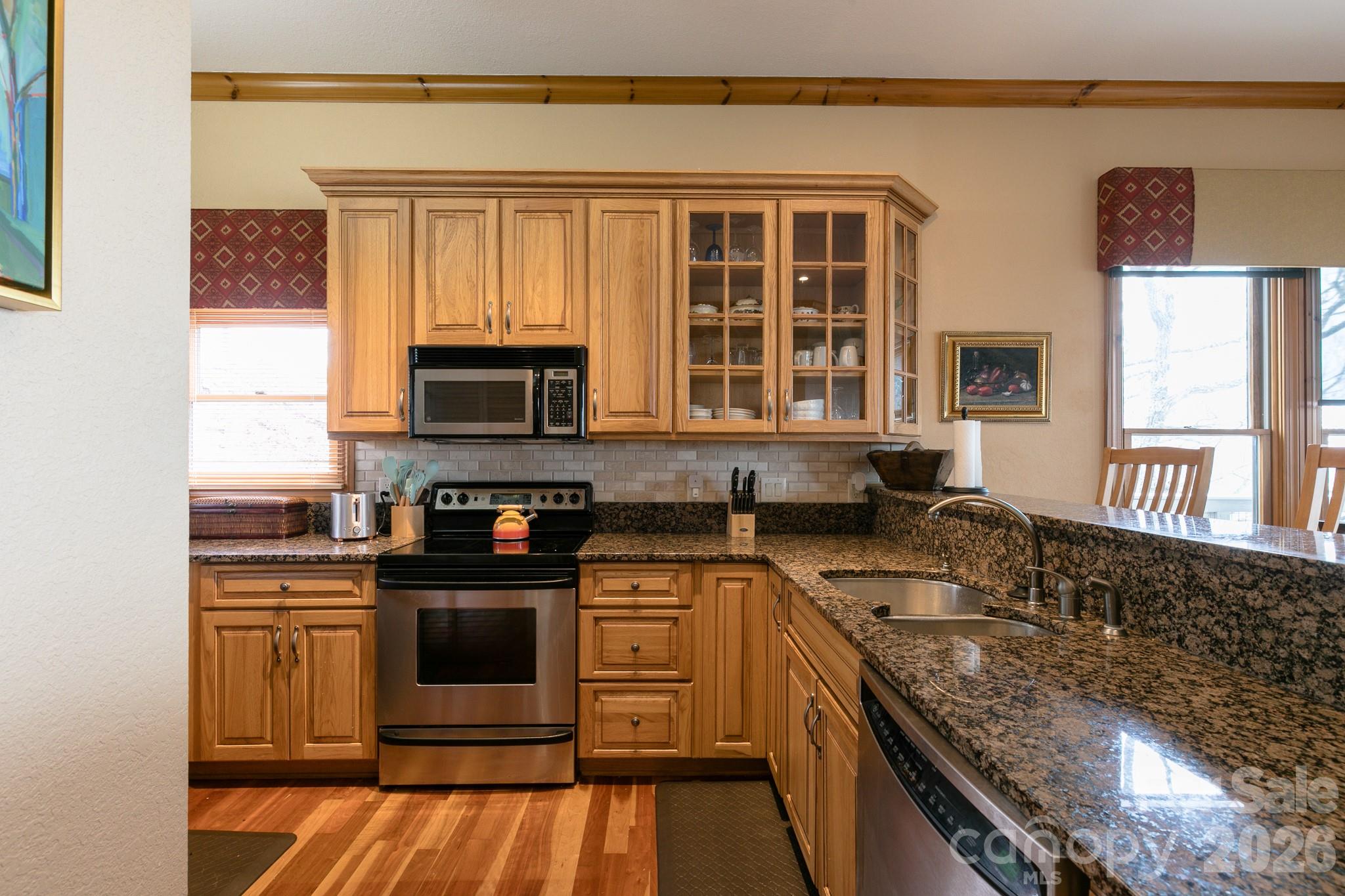 140 Slickrock Road, Unit F3 Burnsville, NC 28714 - Photo 23 of 31 a kitchen with stainless steel appliances granite countertop a stove a sink and a microwave
