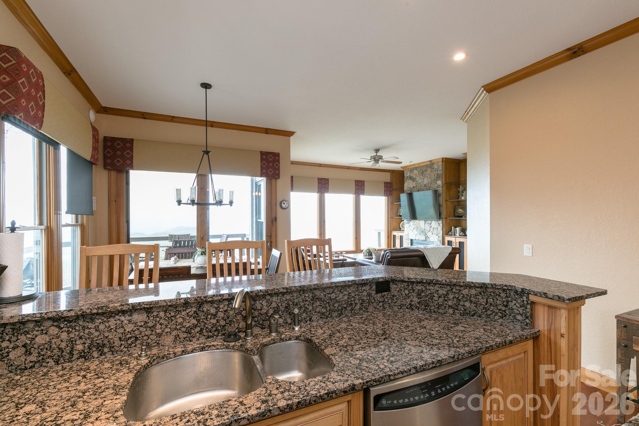 140 Slickrock Road, Unit F3 Burnsville, NC 28714 - Photo 24 of 31 a kitchen with granite countertop a sink and a counter top space