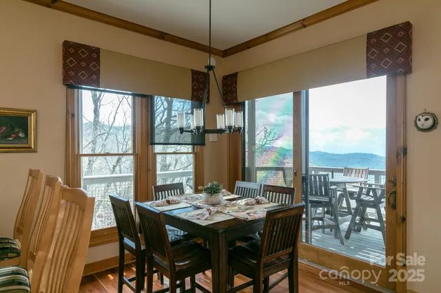 a view of a dining room with furniture large windows and wooden floor