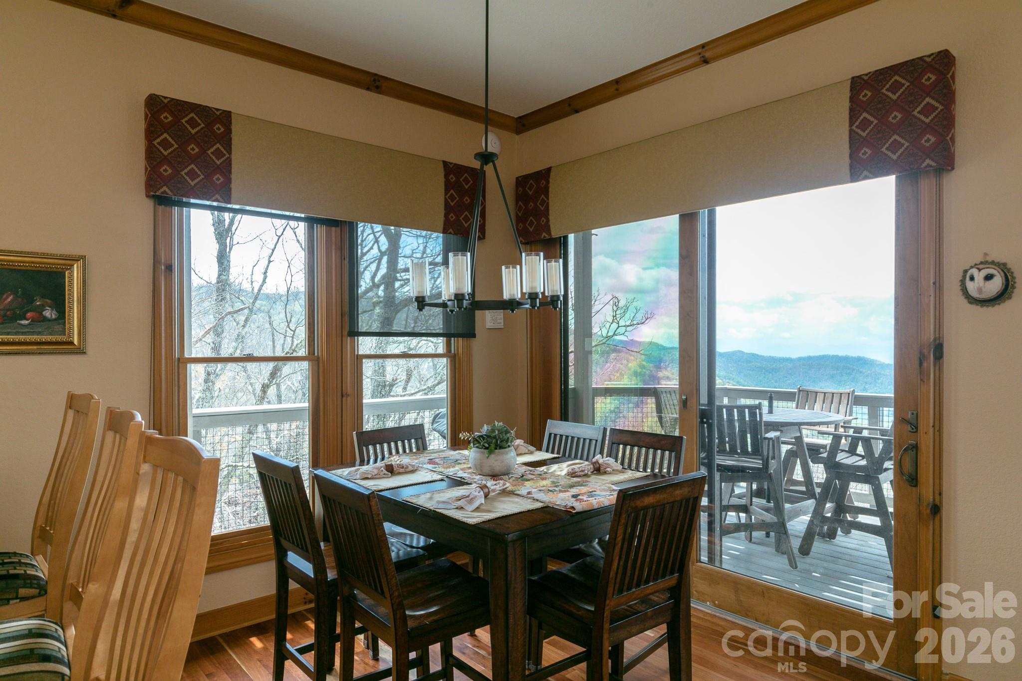 140 Slickrock Road, Unit F3 Burnsville, NC 28714 - Photo 5 of 31 a view of a dining room with furniture large windows and wooden floor