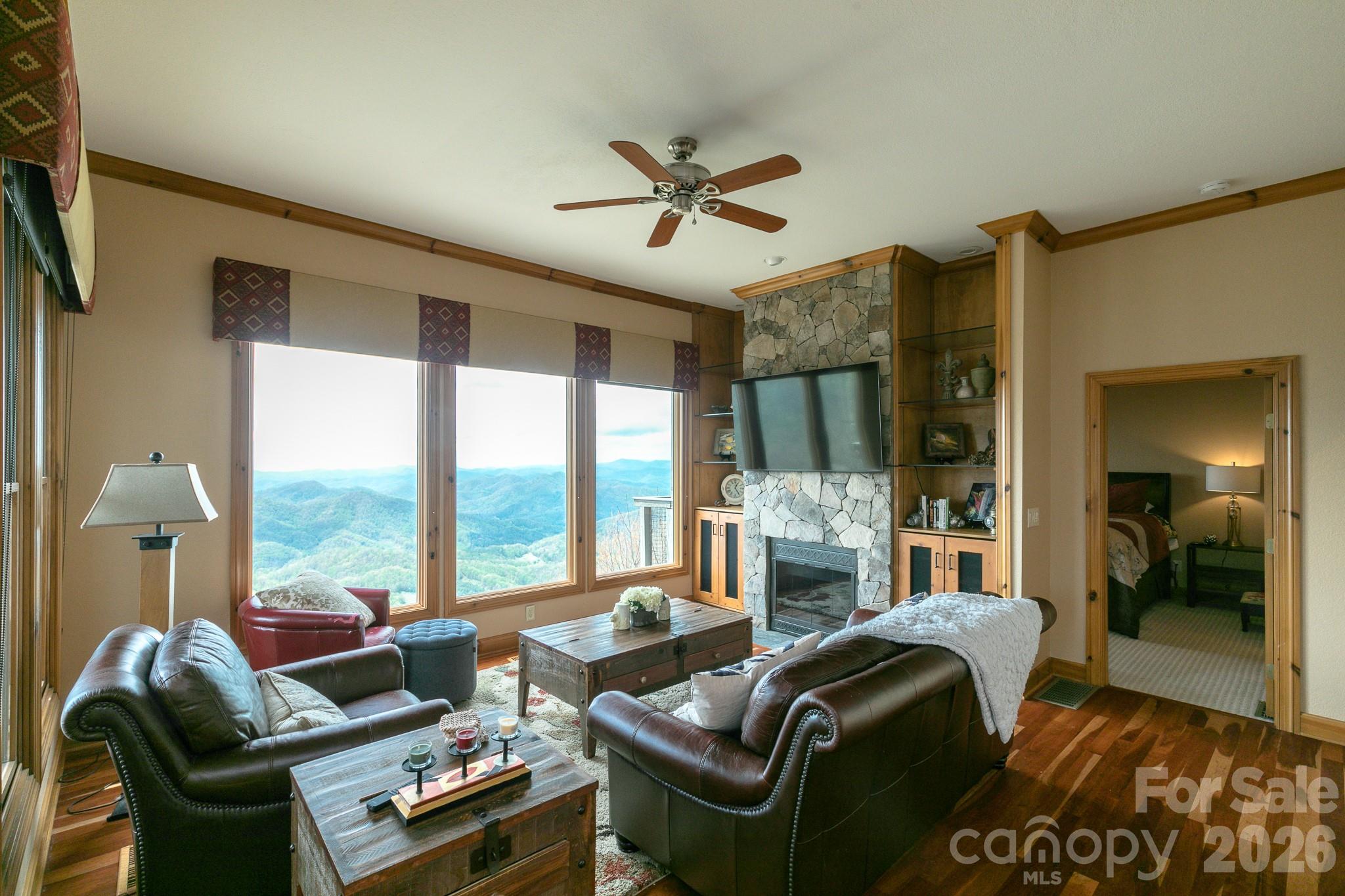 140 Slickrock Road, Unit F3 Burnsville, NC 28714 - Photo 6 of 31 a living room with furniture fireplace and large windows