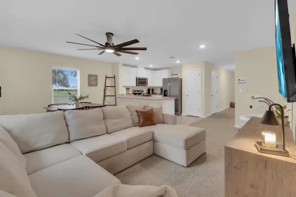 a kitchen with a refrigerator a microwave a sink and cabinets