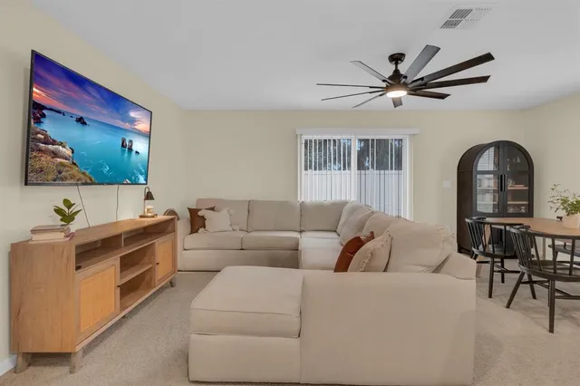 a kitchen with stainless steel appliances granite countertop a sink a stove a refrigerator a center island and cabinets