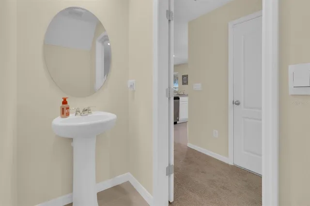 a bathroom with a granite countertop sink a toilet and a mirror