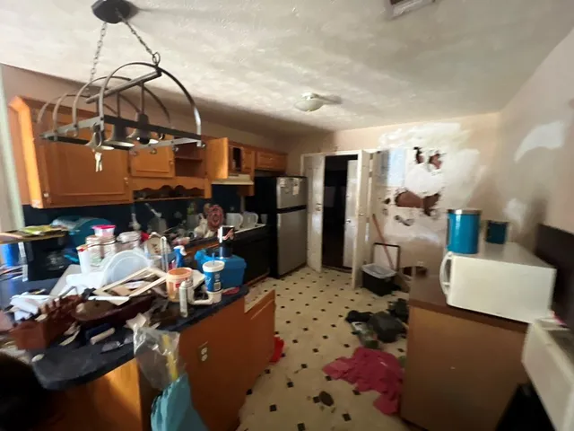 a room with lots of furniture and clutter