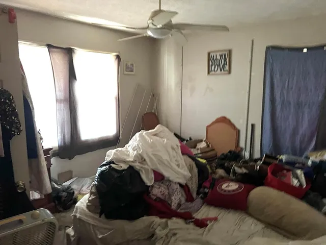 a bed room with a bed and a chair