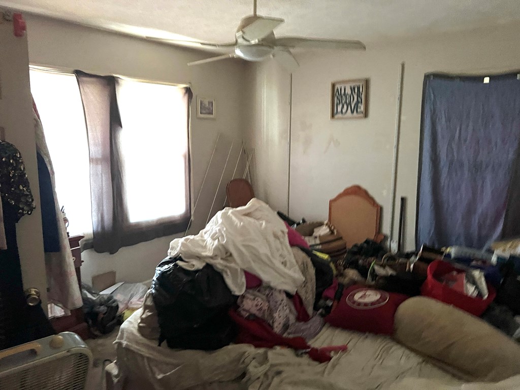 927 Vineville Street Columbus, GA 31904 - Photo 3 of 11 a bed room with a bed and a chair