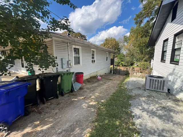 a view of a house with backyard and sitting area